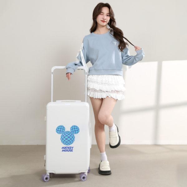 Model posing with white MICKEY suitcase, showcasing stylish travel design for IP - licensed wholesale