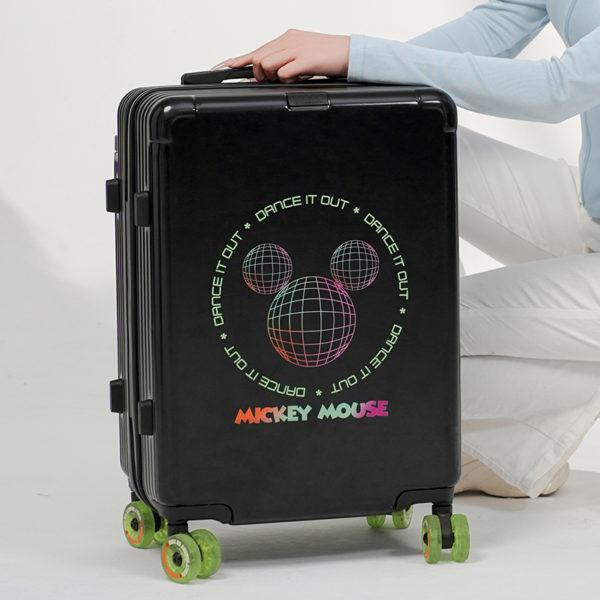 Person showcasing black MICKEY suitcase, highlighting stylish design for IP - licensed wholesale