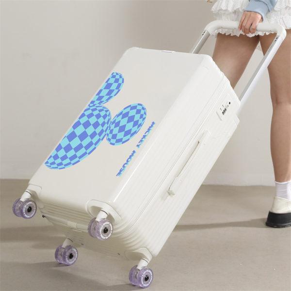 Person pulling white MICKEY suitcase, showcasing travel - ready functionality for wholesale