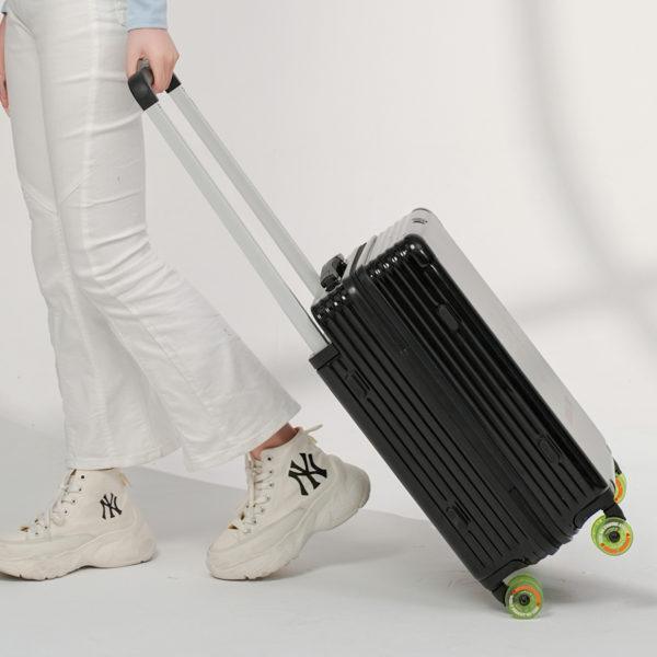 Person pulling black MICKEY suitcase, highlighting travel - ready style for IP - licensed wholesale