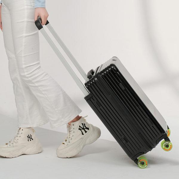 Person pulling black MICKEY suitcase, emphasizing travel - ready functionality for wholesale