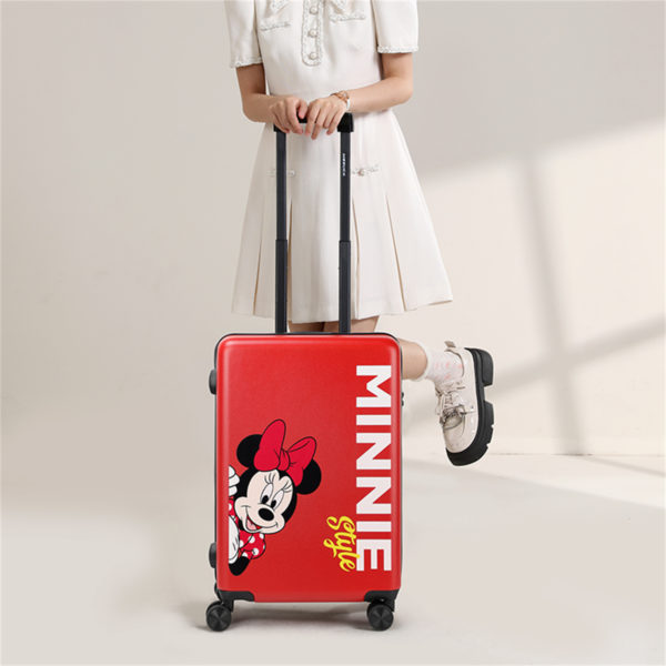 Model with 20-inch red Minnie suitcase featuring “MINNIE Style” and peeking Minnie graphic, perfect for wholesale & Disney IP business