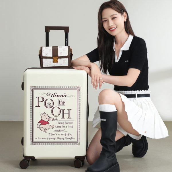 Top view of the Winnie the Pooh 20-inch suitcase, highlighting the sturdy handle and sleek design.